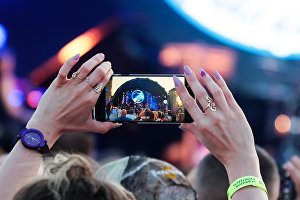 A girl recording the Dave Yaden Band (US) on stage at the 17th Koktebel Jazz Party international music festival
